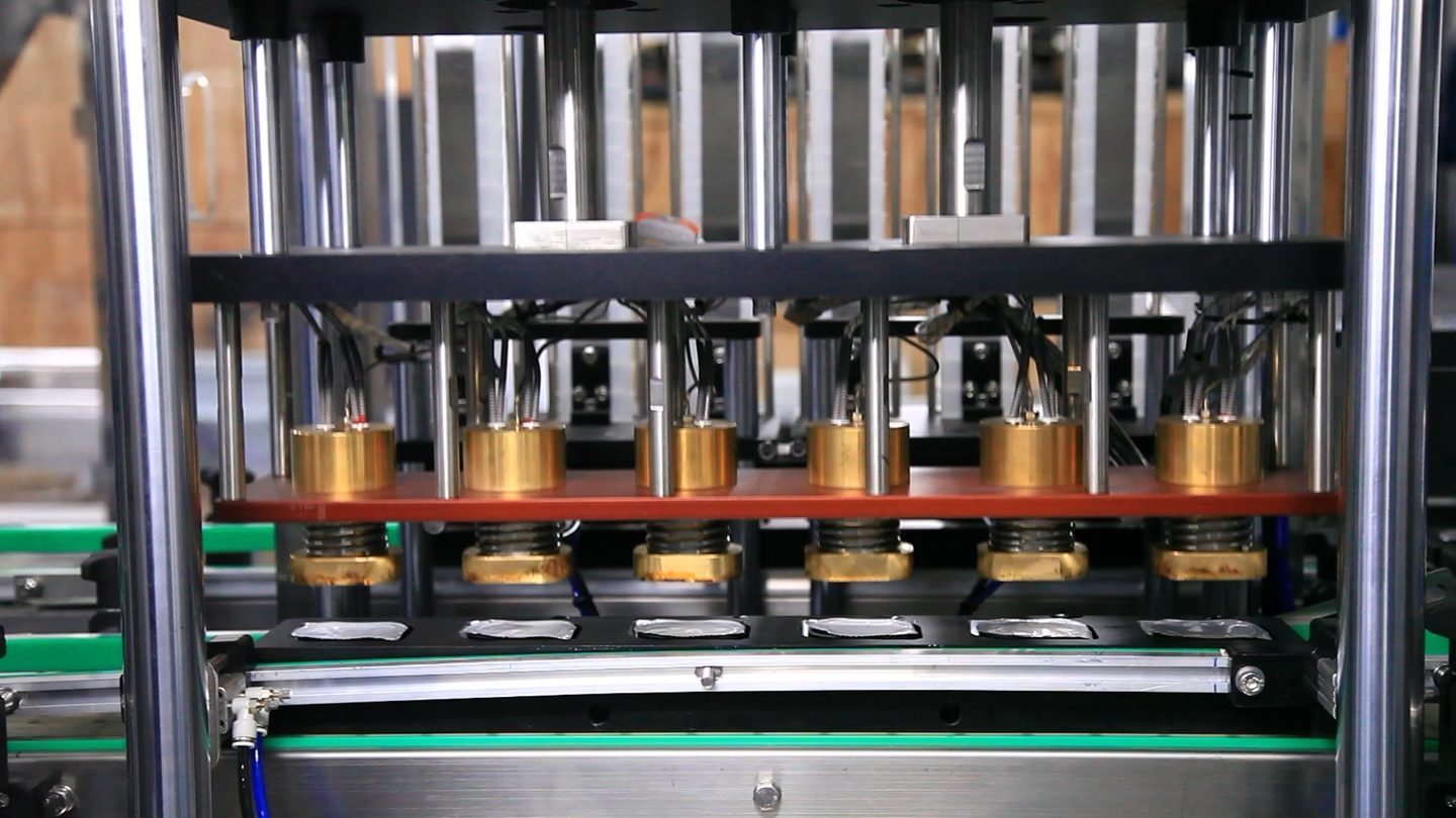Cup filling and film-sealing line